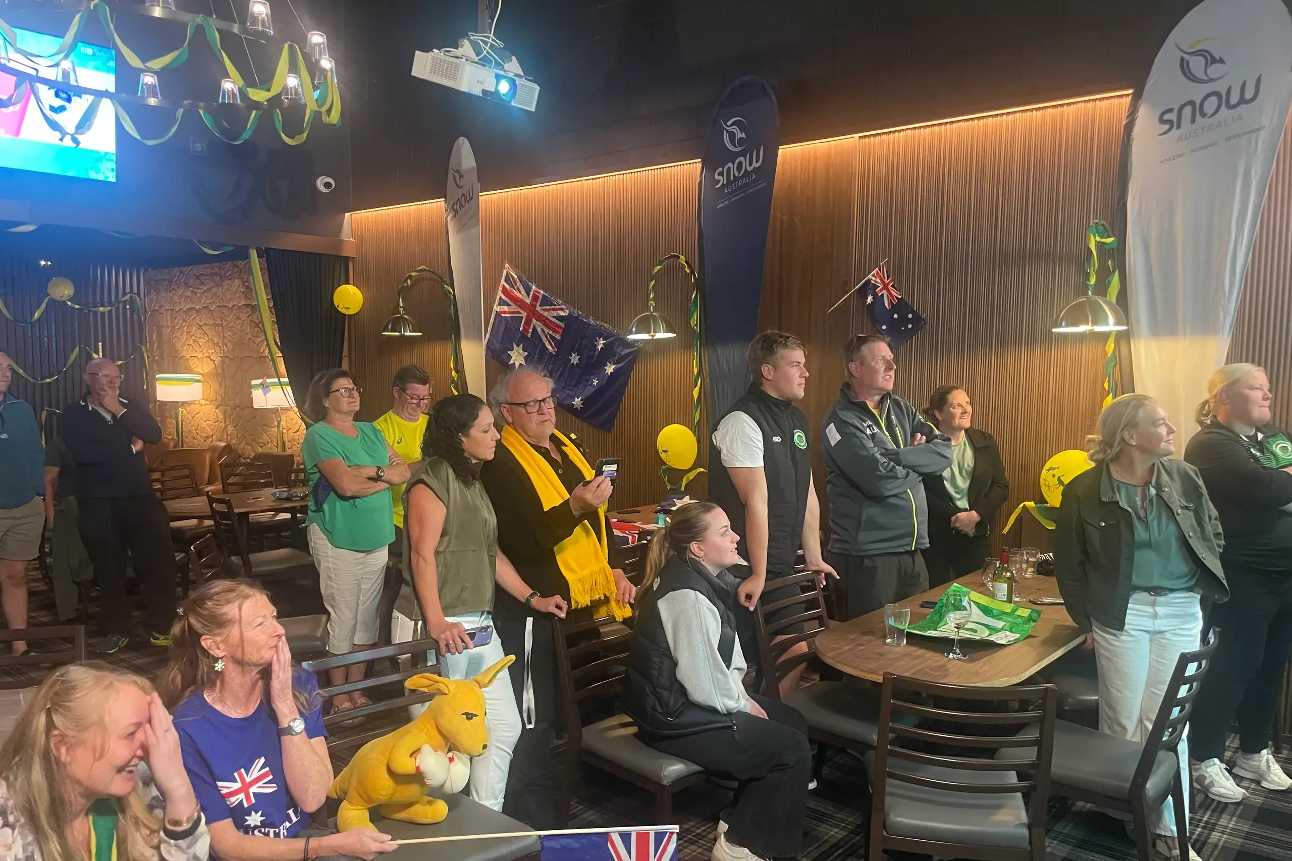 <p>CELEBRATION: A Jindabyne crowd awaits the final score for mogul talent Cooper Woods. Woods claimed Winter Olympic gold with one of the great performances. PHOTO: Nathan Thompson</p>\\n