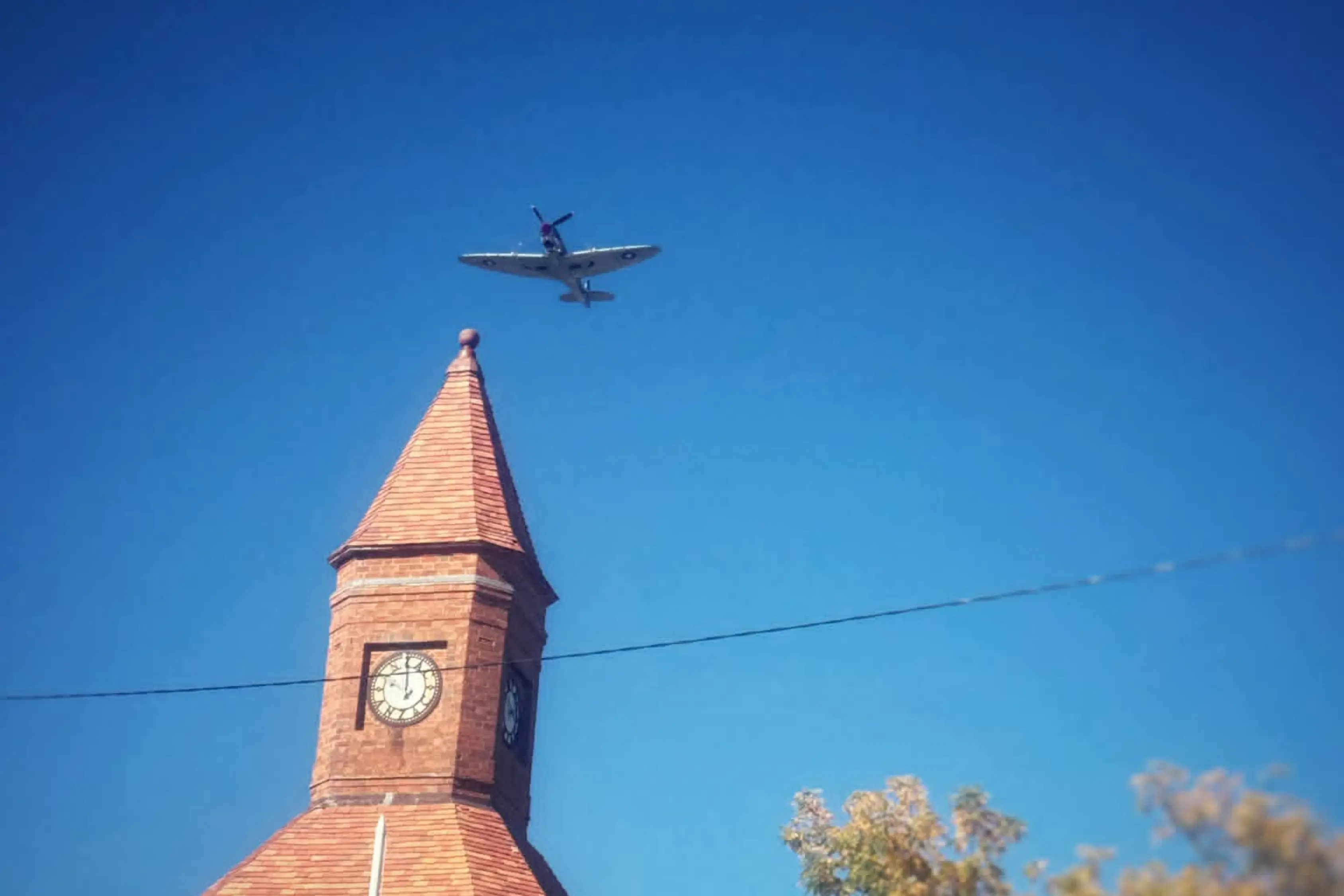 <p>A WWII-era Spitfire passes over the Boorowa War Memorial during ANZAC Day commemorations. Photo: Ryan Long</p>\\n