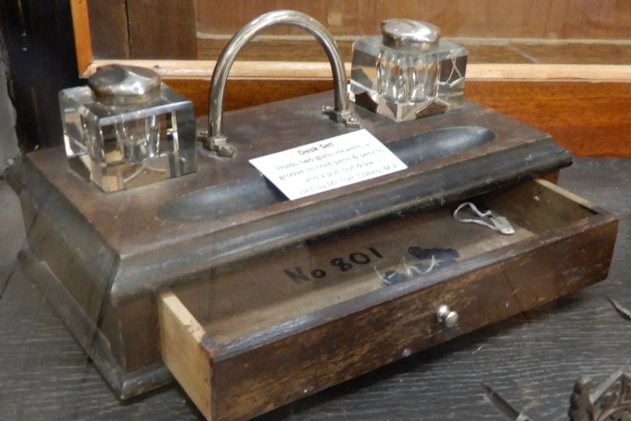 <p>The Young Historical Museum displays a desk set used by Tom. It holds two glass inkwells and has a pull-out drawer. </p>\\n