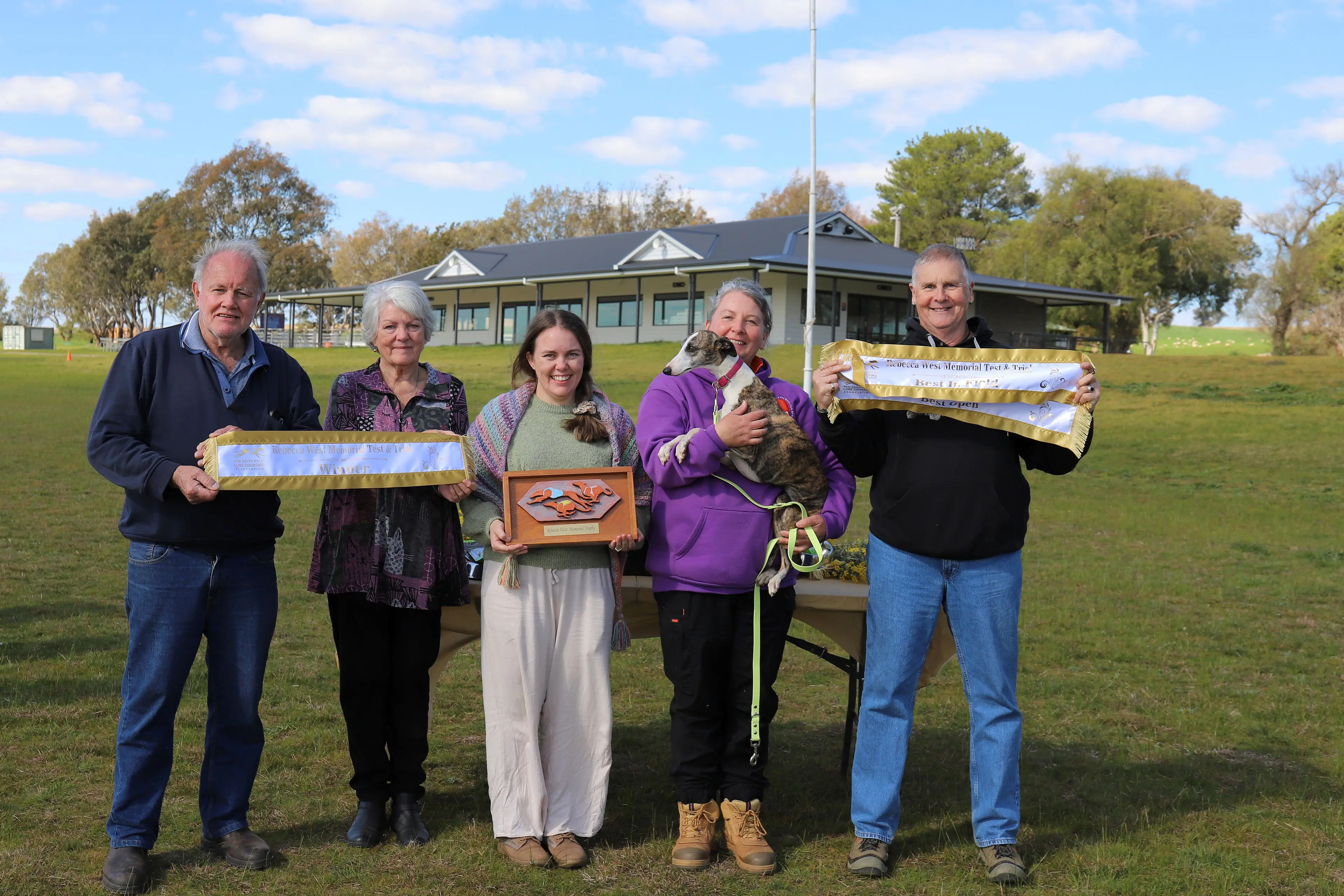 <p>Pictured are Bec\\'s family, Jacki, with Sprite and Lure Coursing Judge Bear Paintain. PHOTO: Supplied</p>\\n